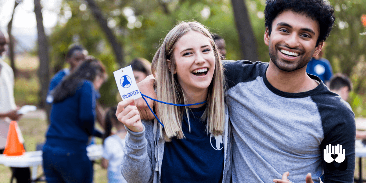 Two volunteers smiling