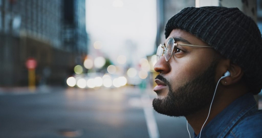 man listening to music in city