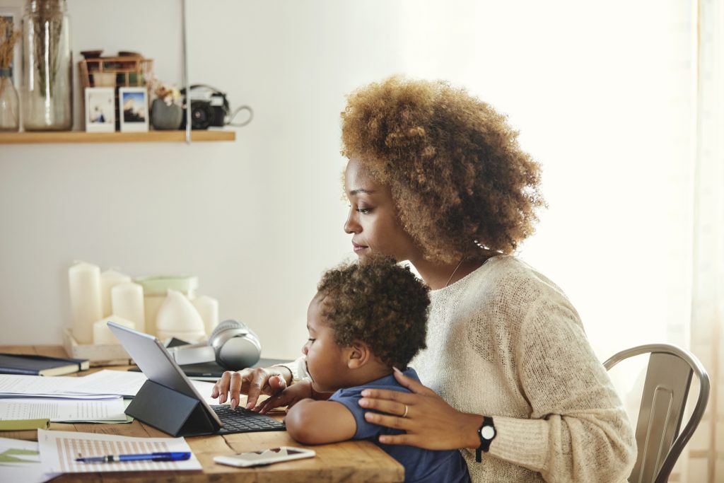 woman with child looking at tablet