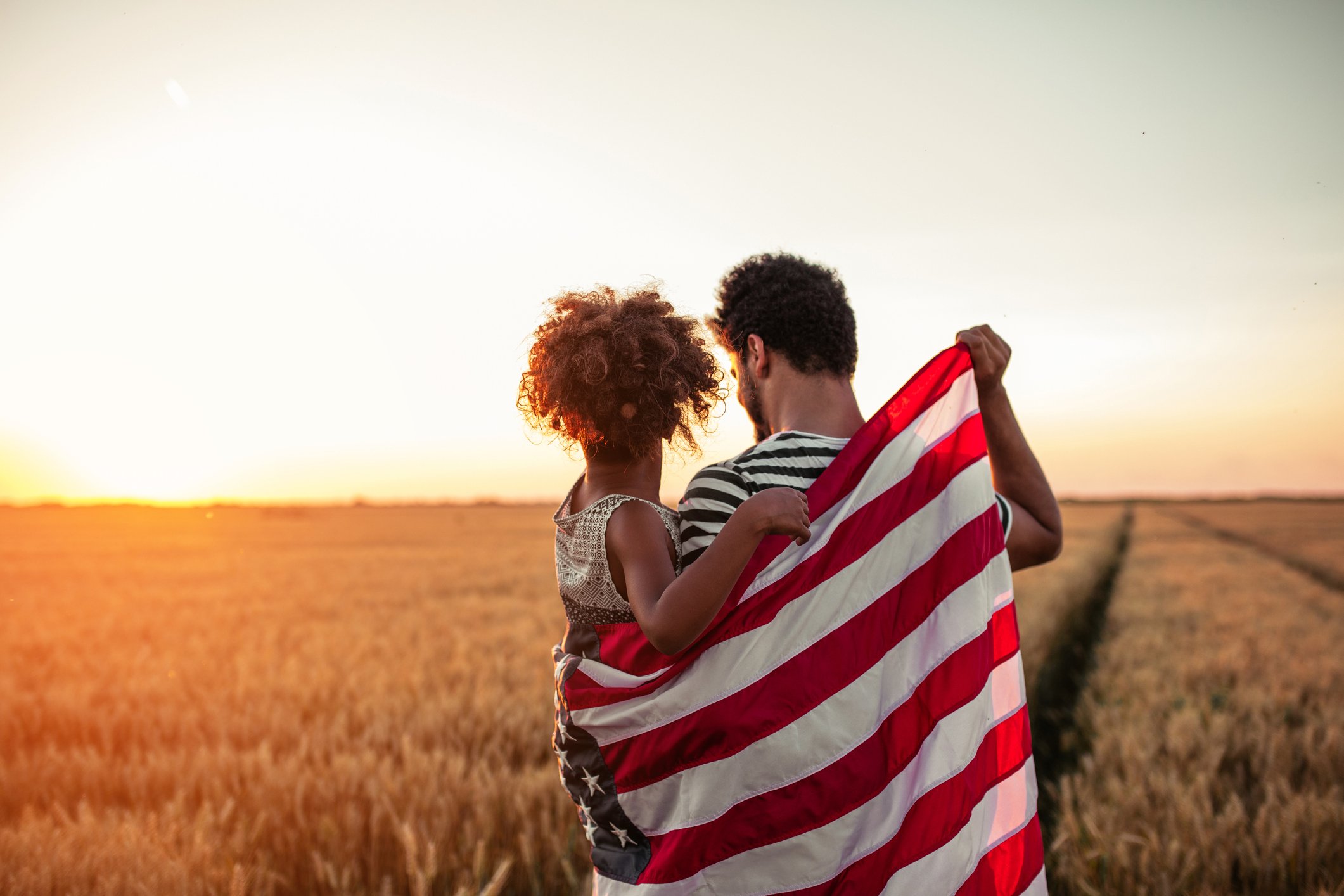 FatherandDaughterHoldingAmericanFlag