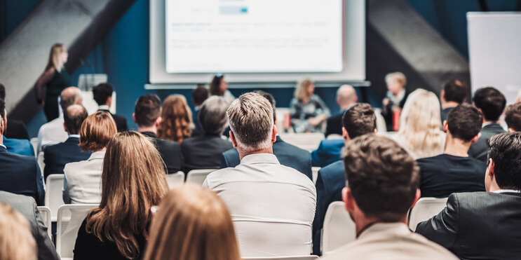 An audience gathered for a speaker session at an association event.