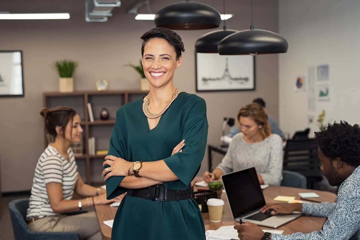 Smiling woman with folded arms in an office