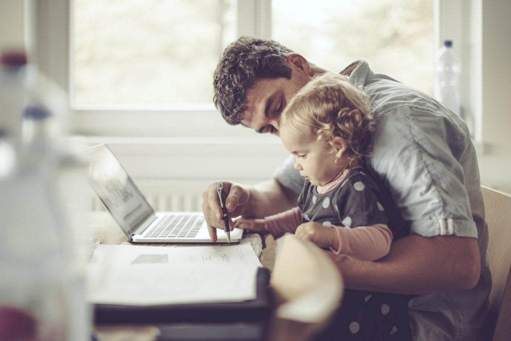 Dad on computer with daughter