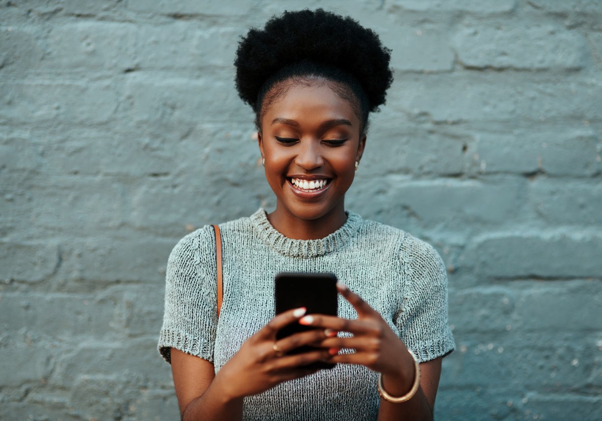 Woman smiling at her phone